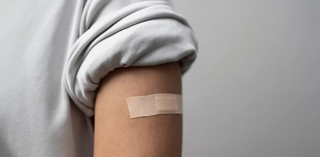 A bandaid is placed on a person Flu vaccines are now available for 2025. What’s on offer and which one should I get