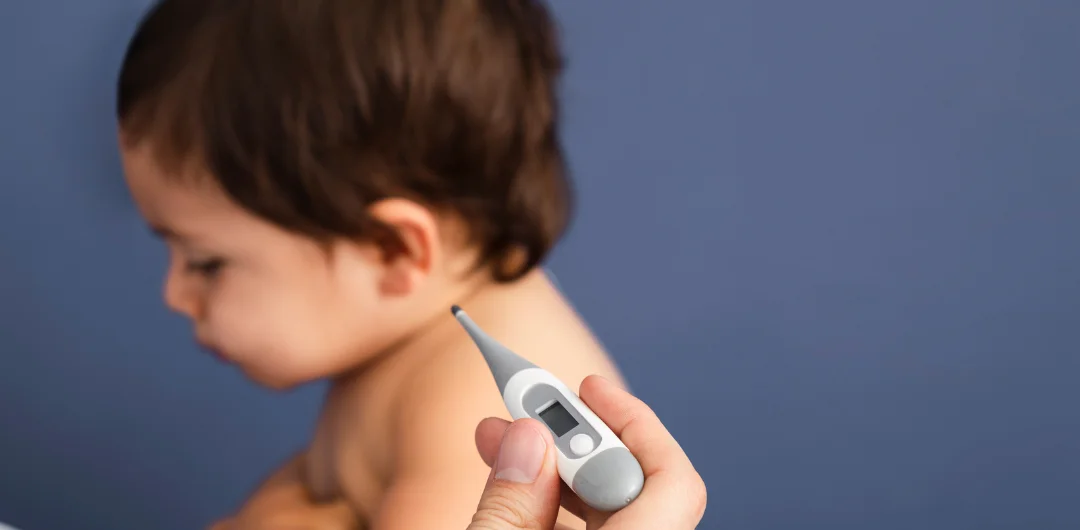 The Global Rise of Measles close-up-doctor-checking-baby-temperature 2